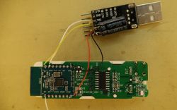 Electrolytic Capacitor Added to USB-TTL with ESP Module Close-up of a PCB with a connected USB-TTL module and a large electrolytic capacitor.