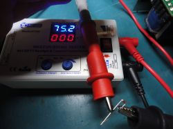 Multifunction tester KT4H with probe wires and a component.