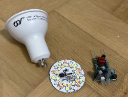 Disassembled GU10 smart LED bulb with visible components.