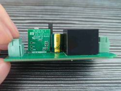 Circuit board with electronic component and technical markings.