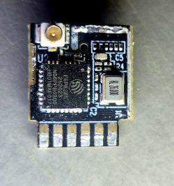 ESP8285 module with visible electronic components on a PCB.