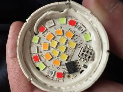 Inside of Moes 5W RGB+CCT E12 Bulb Teardown of Moes bulb showing internal components.