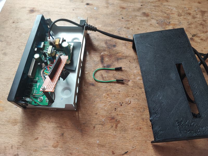 Modified Satellite Tuner as Development Platform Open case of a modified satellite tuner with visible circuit board and wiring on a workbench.