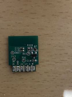 Close-up of a small green circuit board with electronic components.