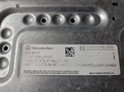 Label on a metal housing: Mercedes‑Benz, Harman/Becker, part numbers, and a 2D code.