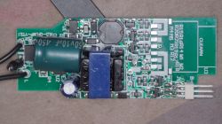 Close-up of a green PCB with power-supply components and a printed PCB antenna