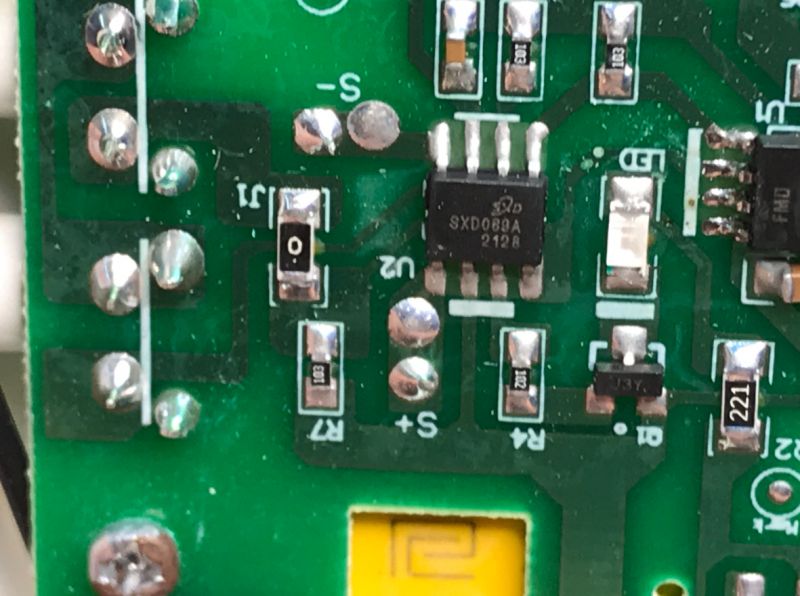 Printed Circuit Board with Electronic Components Close-up of a green printed circuit board with various electronic components.