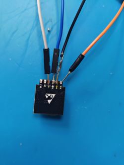 BL602 Switch Module with Wires Switch module with soldered wires on a blue background.