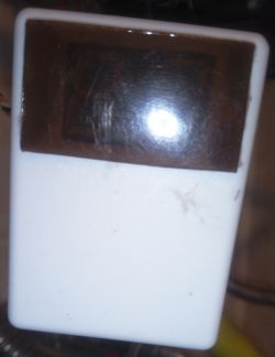 White enclosure with dark translucent panel for an LED display.