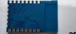Blue electronic module with visible circuit traces and soldering points.