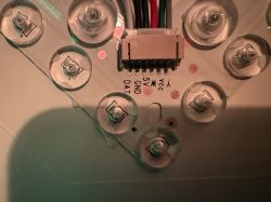 Close-up of wire connector and LED lights on a printed circuit board