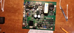 Płytka PCB z podzespołami elektronicznymi, leży na drewnianym blacie