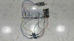 Electronic circuit on breadboard with modules and USB power supply Breadboard connected with wires to electronic modules and USB power supply.