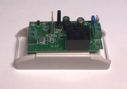 WiFi-Controlled Relay PCB PCB of a relay with electronic components on a white base.