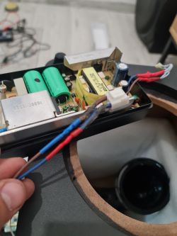 Close-up view of the interior of an electronic device with a circuit board and wiring.