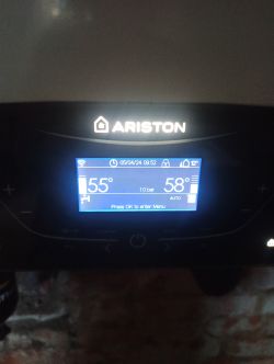Ariston room controller screen displaying temperatures of 55°C and 58°C.