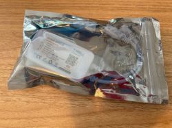 LED Controller in Original Packaging LED controller in a ziplock plastic bag on a wooden surface.
