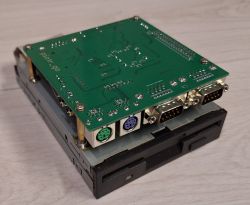 Close-up of a custom computer hardware setup with a circuit board and various ports.