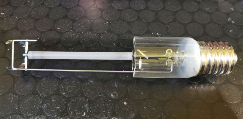 Glass bulb with E27 socket and internal components on black textured surface