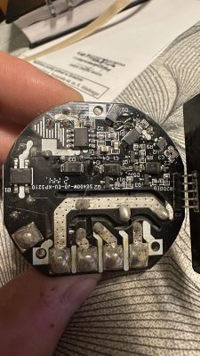 Image of a round circuit board with visible electronic components and soldering.