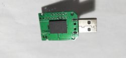 Green PCB with a mounted USB connector and chip.