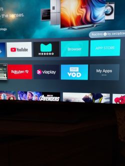 TV screen displaying apps such as YouTube, Megogo, browser, App Store, Rakuten TV, Viaplay, and TVP VOD.