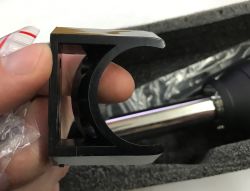 Plastic bracket for hot air station held in hand above packed device with nozzle