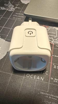 Tuya Smart Plug on World Map White Tuya smart plug lying on a world map.