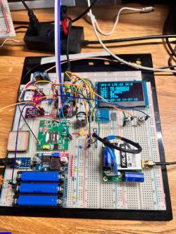 GPS Tracker Prototype on Breadboard GPS device prototype on a breadboard with components and an OLED display.