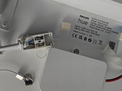 Zbliżenie na wewnętrzne podłączenie lampy sufitowej LED Philips Hue Surimu z widocznymi przewodami.