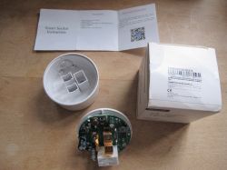 Disassembled Smart Plug with Box and Instruction Manual Disassembled smart plug with instruction manual and packaging.