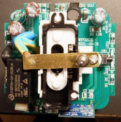 Top view of an opened electrical plug with visible electronic components.
