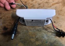 DIY Smart Switch for Fan Control Modified smart switch with wires on a wooden table