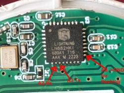 Close-up of a PCB with a “LIGHTNING” IC and red arrows labeling pins A2 Rx, A3 Tx, and A9→GND for flashing