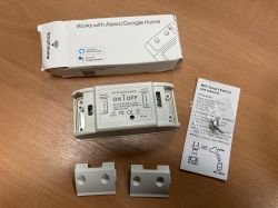 Sonoff WHD06 smart Wi-Fi switch set on a table.