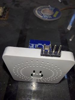 Electronic device with pins protruding from the side on a dark surface.
