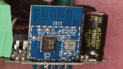 Blue CB2S PCB module with antenna trace and 26.000 MHz crystal next to a black capacitor