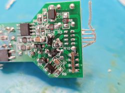 PCB board with electronic components, soldering residues, and visible wire connections