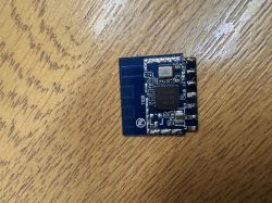 Electronic module with chip and antenna on a wooden surface