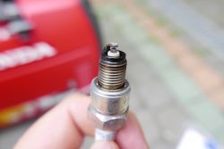 Spark Plug from Honda Generator Close-up of a spark plug from a Honda generator.