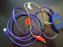 Modified VAG KKL cable with added wires and clips on a black background