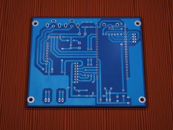 Single-sided blue PCB with light blue tracks and multiple through-holes for component mounting