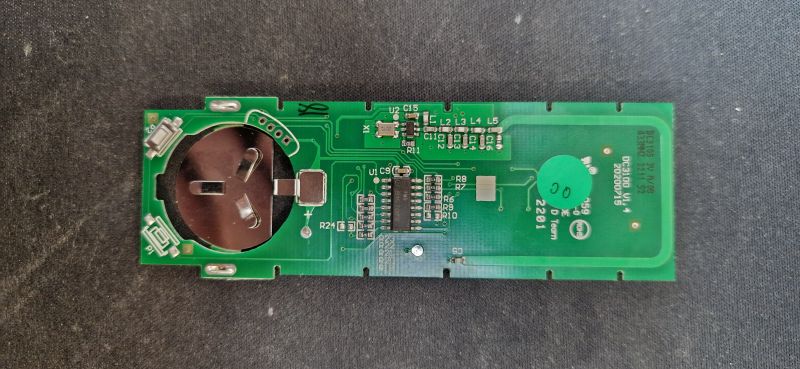Remote Control Circuit Board Remote control circuit with visible battery compartment and electronic components.