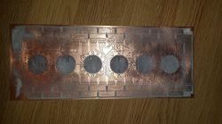 Printed Circuit Board with Nixie Tube Cutouts Printed circuit board with cutouts for nixie tubes.