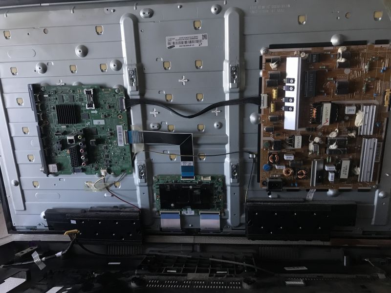 Open Television with Visible Internal Components Interior of an open television showing circuit boards and electronic components.