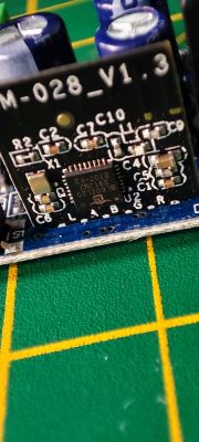 Close-up of a circuit board labeled SM-028_V1.3 with electronic components.