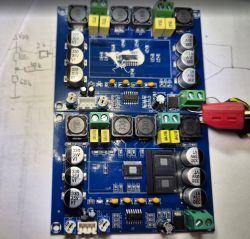Audio amplifier module on a blue PCB with components and terminal connectors