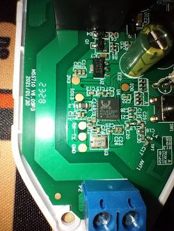 Close-up of a circuit board with electronic components, including a capacitor, RTL8720CF chip, and screw terminal.