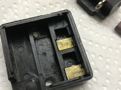 Interior of a Vintage Drill Switch Casing Inside of a plastic switch casing with visible contacts.