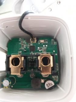Interior of a smart plug showing the circuit board and electronic components.